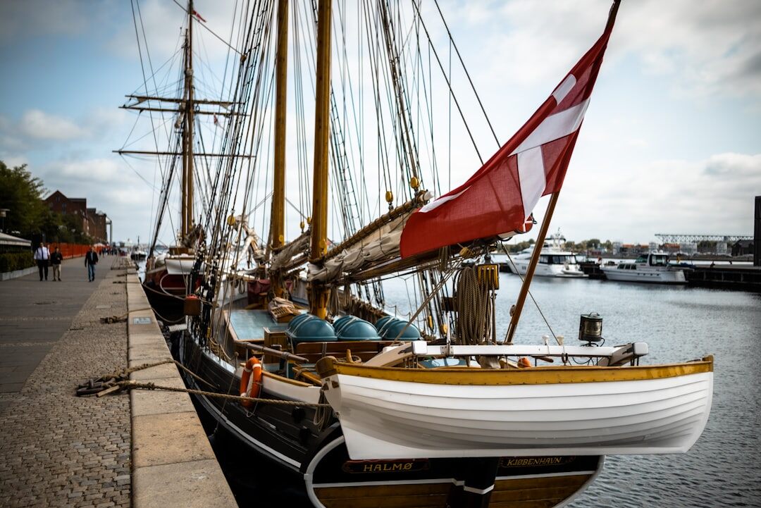 Elderly Danish fisherman mending nets on a boat